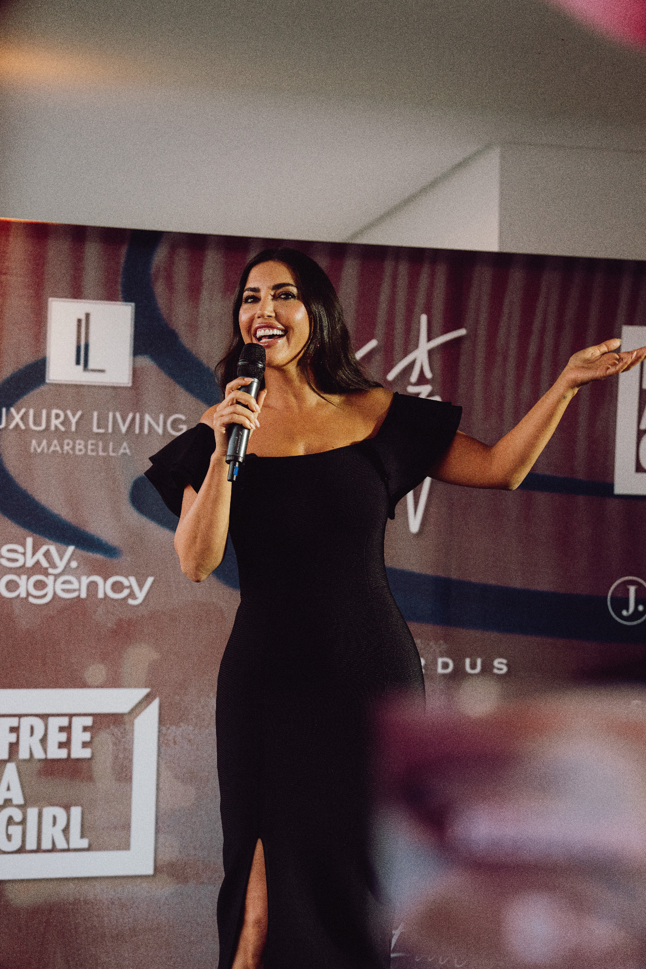 Host on stage at the Free a Girl × JEEJ Marbella Charity Night 2026